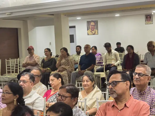 Guests seated in rows in a hall, listening to the performance